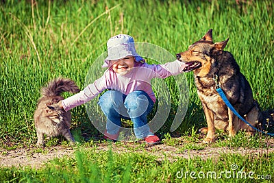 Little girl playing with dog and cat Stock Photo