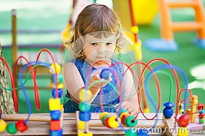 Little girl playing with labyrinth educational toy. Stock Photo