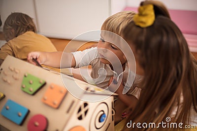 Little girl playing with her brother. Fun with interactive game Stock Photo