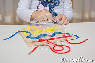 Little girl playing in Montessori educational game. Stock Photo