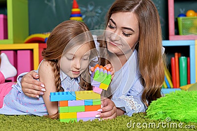 Little girl playing with mother Stock Photo