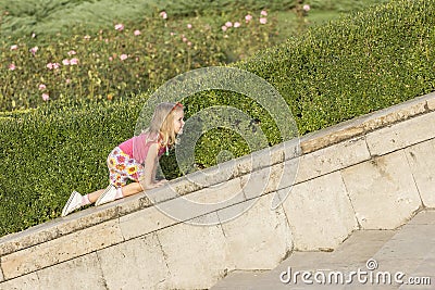 Little girl playing on parapet Stock Photo