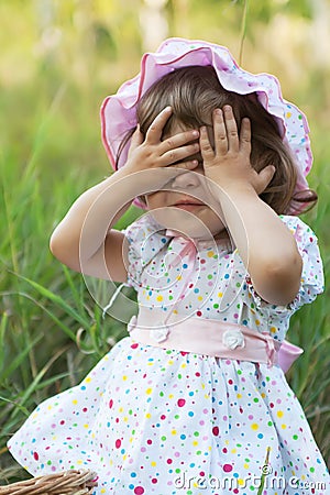 Little girl playing peek-a-boo Stock Photo