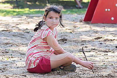 Little girl playing with sand Stock Photo