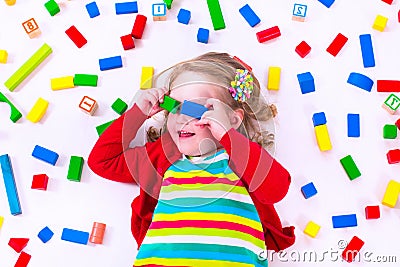 Little girl playing with wooden blocks Stock Photo