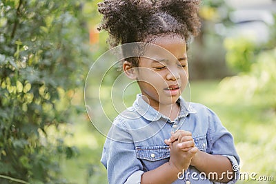 Little girl praying. kid prays. Gesture of faith.Hands folded in prayer concept for faith,spirituality and religion. Stock Photo