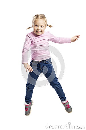 Little girl of preschool age in a pink sweater and jeans is jumping. Isolated over white background Stock Photo