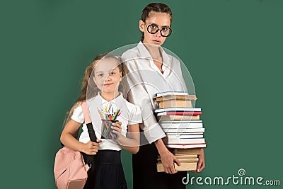 Little girl in private school, pupil and teen schoolgirl. Lesson and reading grammar book. Stock Photo