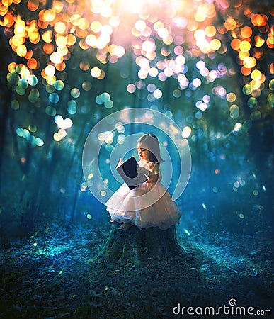 Little girl reading a book Stock Photo