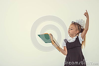 Little girl reading book, preparing for school Stock Photo