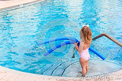Little girl ready to jump into the pool with noodle Stock Photo