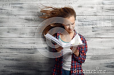 Little girl reding a book against powerful airflow Stock Photo