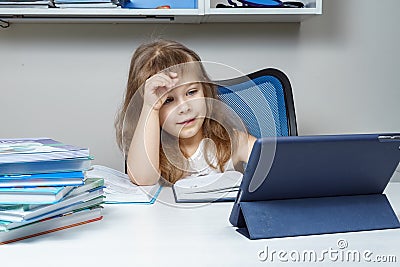 little girl on a remote online lesson with a teacher. remote learning during the COVID-19 pandemic. Stock Photo
