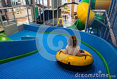 Little girl rides in wheel on the slide Editorial Stock Photo