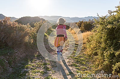 Little girl running through the Spanish landscape Stock Photo