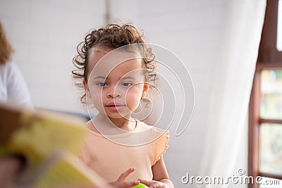 Little girl's father read stories to children before going to bed to unwind and sleep soundly Stock Photo