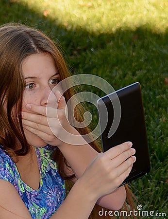 A little girl scared of what she sees online. Stock Photo