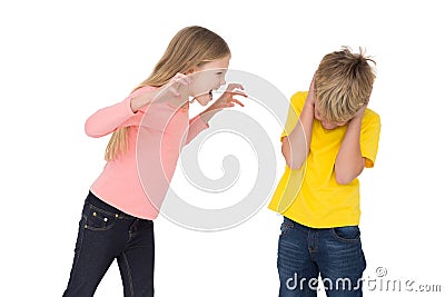 Little girl scaring her brother Stock Photo