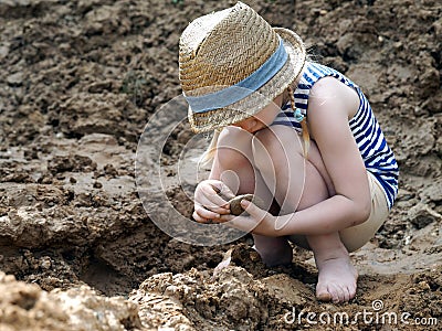 Little girl sculpts out of clay Stock Photo