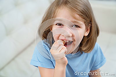 Little girl shows a reeling tooth. changing milk teeth to indigenous teeth. Stock Photo