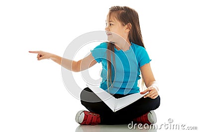 Little girl sitting cross legged and learning Stock Photo