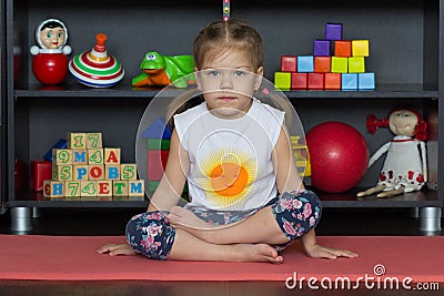 Little girl sitting in easy or lotus yoga pose Stock Photo