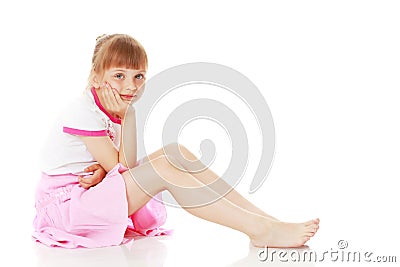 Little girl is sitting on the floor. Stock Photo