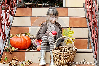 Little girl sitting on stairs outdoors Stock Photo