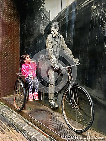 Little girl sitting on a vitage bicyle Editorial Stock Photo