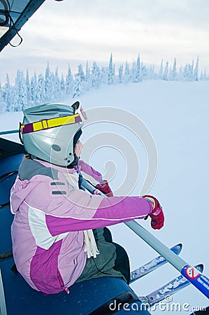 Little girl-skier on the ski lift Stock Photo