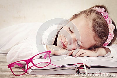 Little girl sleeping on the books Stock Photo