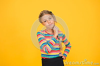 Little girl. Small child with cute braids hairstyle on yellow background. Child care concept. Preteen girl colorful Stock Photo