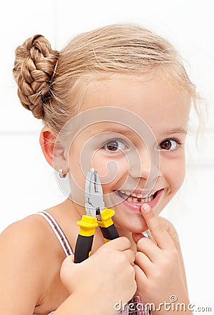 Little girl smiling holding her missing tooth Stock Photo