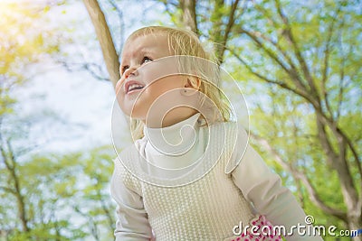 Little girl smiling in a park a sunny day. Stock Photo