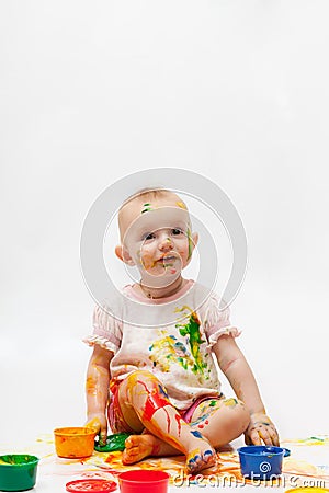 Little girl soiled by bright paints Stock Photo