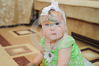 Little girl soiled by multi-colored paints. Stock Photo