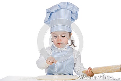 Little girl sprinkle flour on pizza dough Stock Photo