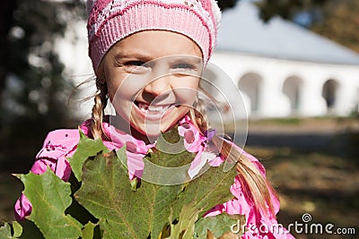 Little girl squints from sun Stock Photo