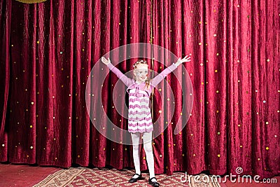 Little girl standing on stage during a performance Stock Photo