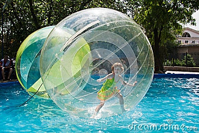 Little girl stands in a balloon floating on water in city park in Volgograd Editorial Stock Photo