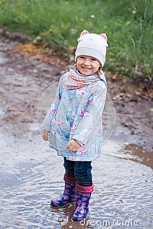 Little girl staying in the puddle Stock Photo