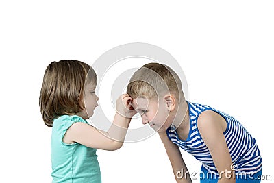 Little girl sticks patch on elder boy forehead Stock Photo