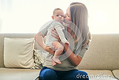 This little girl stole my heart. a young mother and her baby at home. Stock Photo