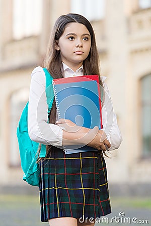 Little girl student school uniform and backpack hold books, academic year concept Stock Photo