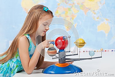 Little girl studies the solar system in geography class Stock Photo