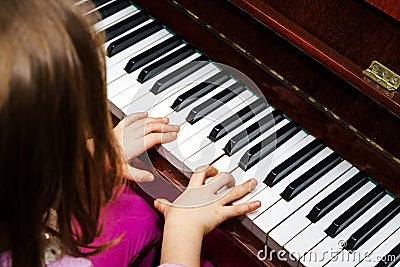 Little girl studing to play the piano Stock Photo