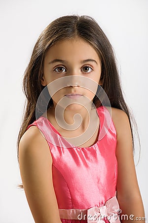 Little girl in a stylish pink dress and sash Stock Photo