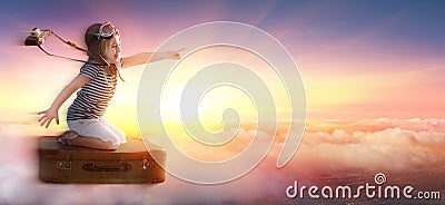 Little Girl On Suitcase In Trip Over Clouds Stock Photo