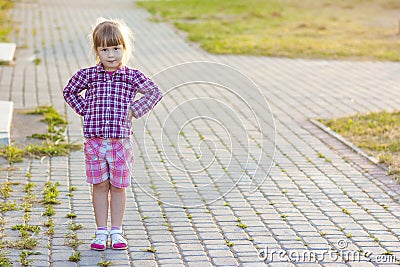 Little girl on summer day standing with hands on hips Stock Photo