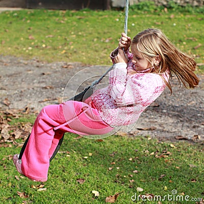 Little girl on a swing Stock Photo